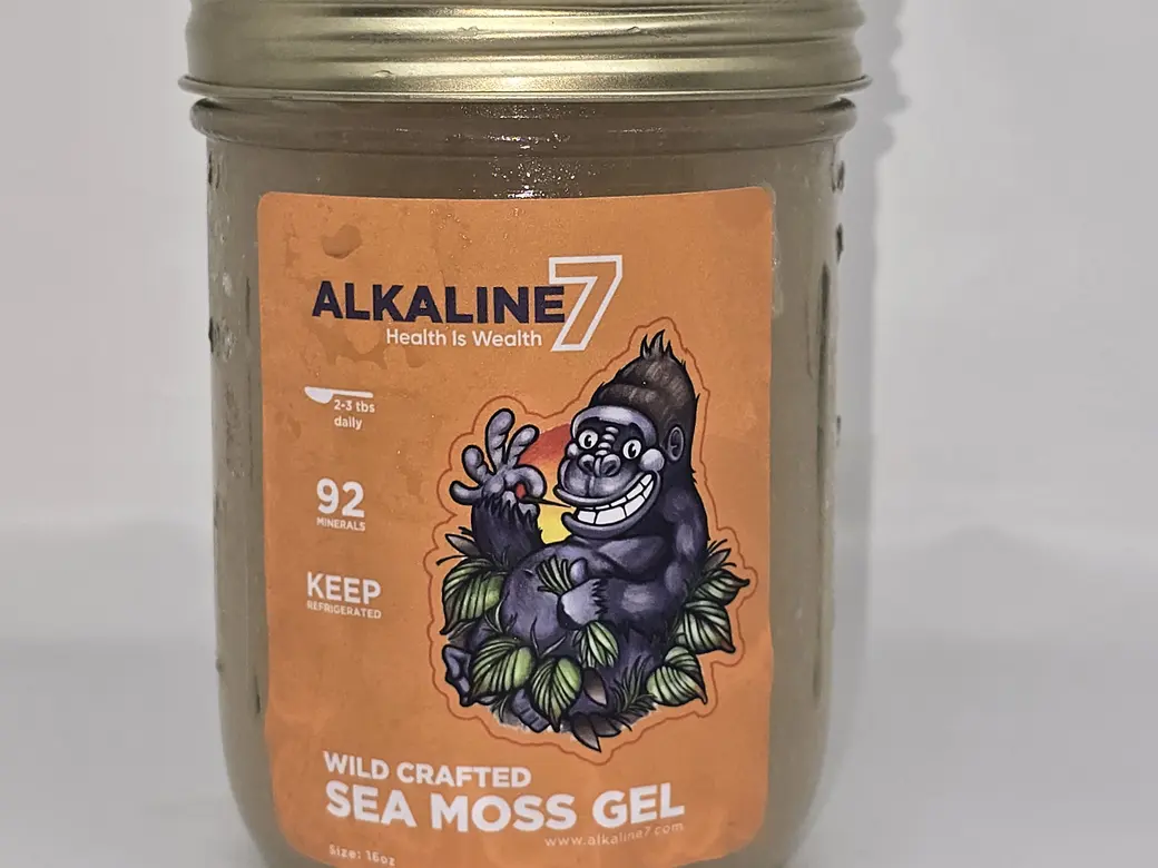 A jar of Alkaline7 Wild Crafted Sea Moss Gel, its label naming the blend, the serving size, and the instruction to keep it refrigerated.